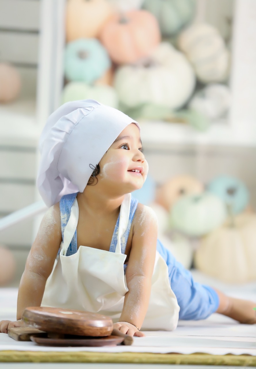 A newborn baby sleeping peacefully in a basket.
