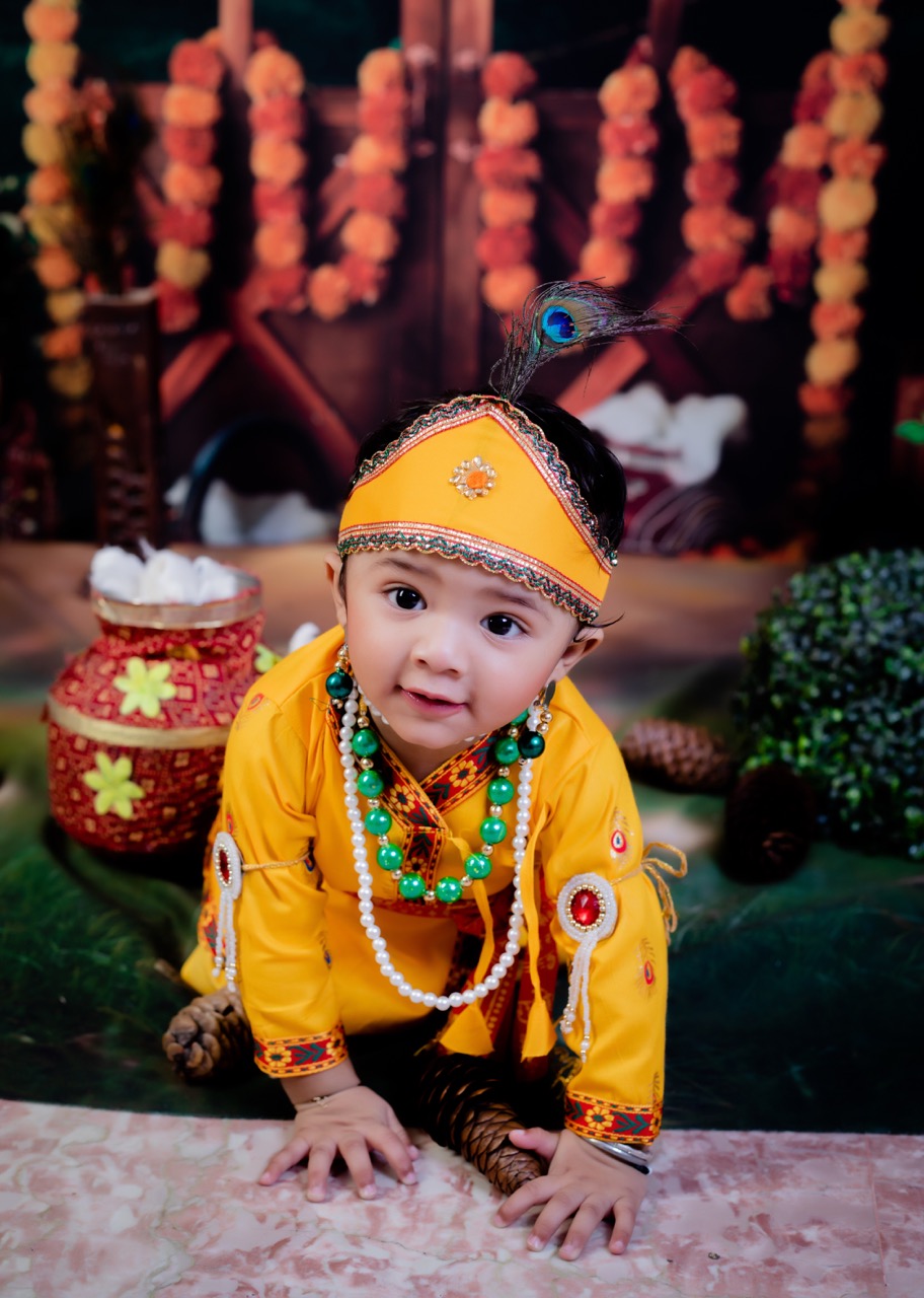 Janmashtami toddler photoshoot — toddler in Krishna costume walking on studio floor