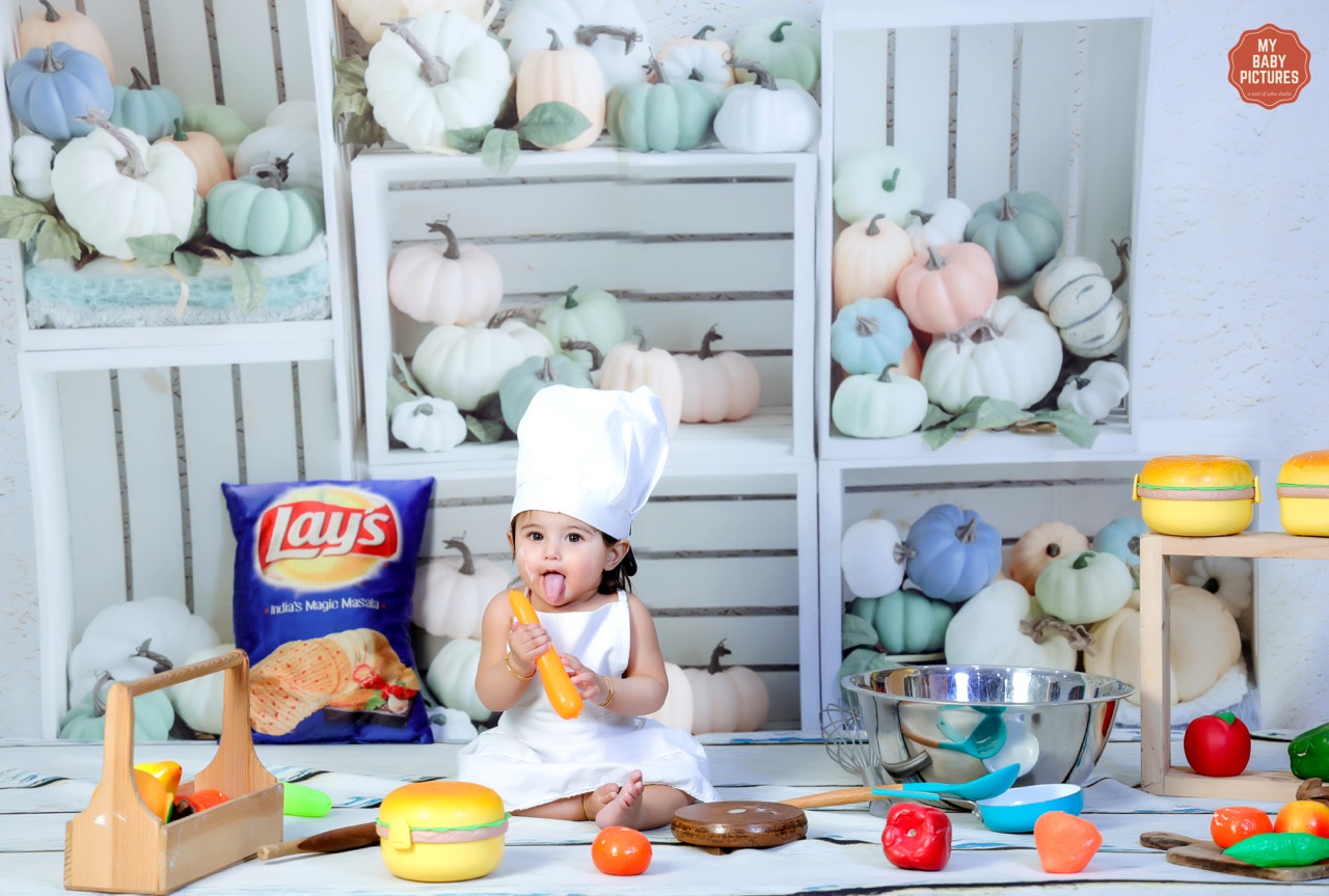 baby photoshoot in chef costume with kitchen theme